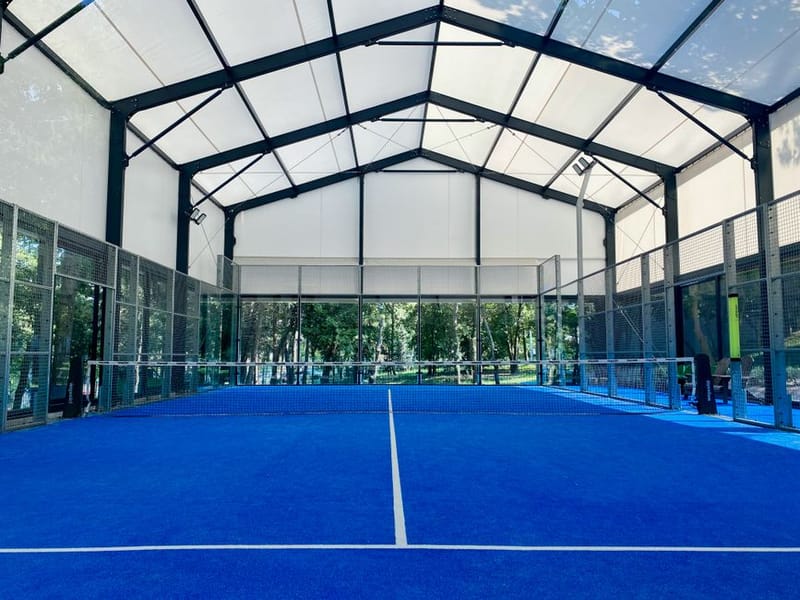 Glass-walled padel court from the baseline