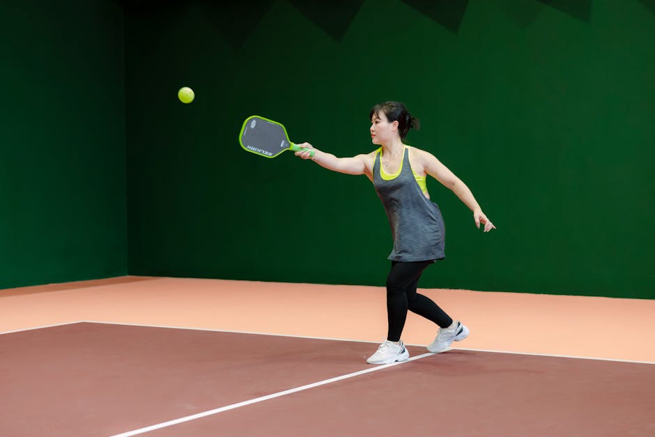 Pickleball players on an outdoor court mid-rally