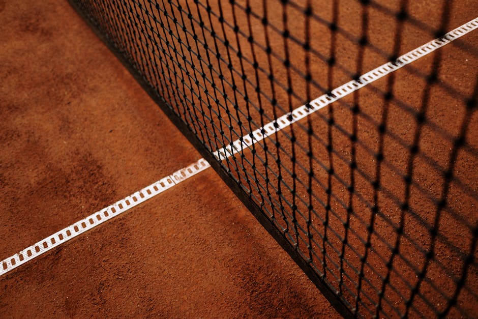 Tennis court lines representing pickleball kitchen non-volley-zone rules